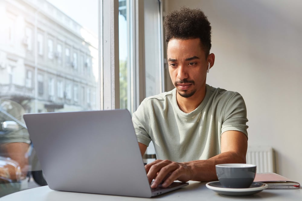 Man-taking-notes-to-improve-his-talent-sourcing-strategy